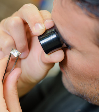 Jeweler examines diamond in Gilbert, AZ