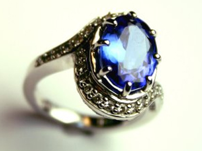 deep blue tanzanite ring set in white gold and surrounded by diamonds